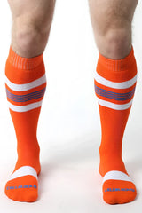 Bright orange tight end knee high socks with white and purple stripes and ribbed cuff and toe design