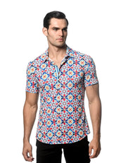 A man wearing a tile printed performance short-sleeved shirt with vibrant blue red and white geometric patterns and contrast placket