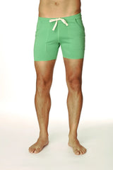 Transition yoga short in bamboo green with mint green fabric, cream drawstring tie, and two front pockets