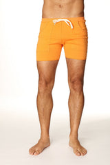 Transition yoga short in sun orange featuring bright orange fabric with white drawstring and two front pockets