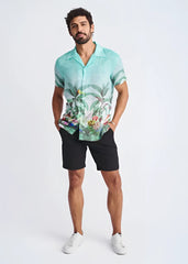 A men’s short-sleeved modal shirt in vibrant turquoise with tropical border print featuring foliage and colorful birds