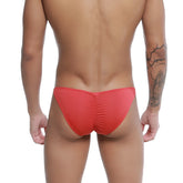 Red u-station me bikini swim trunks with ruched back design in form-fitting fabric for swimwear use shown from back side
