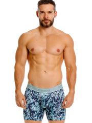 Men’s blue and teal tropical leaf patterned boxer briefs with light gray único branded waistband in color 43-blue