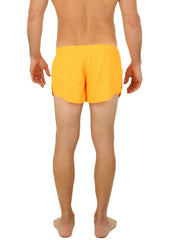 Bright yellow Uzzi running shorts with a relaxed fit and elastic waistband ideal for active use