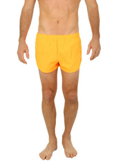Bright yellow Uzzi running short swim trunks with a simple elastic waistband for comfortable active wear