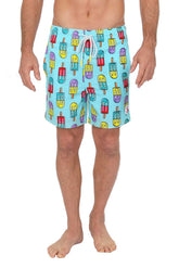 Man wearing light blue UZZI stretch swim shorts featuring a colorful cartoon popsicle pattern and a white drawstring.