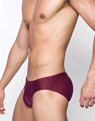 V10 core bikini maroon swim trunks with subtle logo on waistband shown from the back side