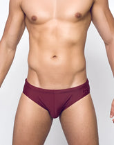 Maroon v10 core bikini swim trunks with subtle logo on waistband ideal for beach and pool use