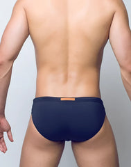 Navy blue v10 core bikini briefs with a small tan rectangular tag at the waistband in cotton fabric