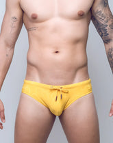 Bright yellow V10 ripple textured swim brief with subtle pattern and matching drawstring for comfortable wear