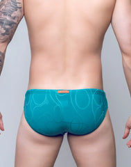 Teal v10 ripple textured swim brief with subtle abstract pattern and orange brand tag at the waistband front side