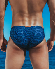 Blue v20 signature print swim brief with light blue abstract line pattern and orange brand tag at the waistband