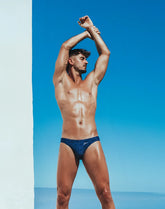 Navy blue v20 signature print swim brief with subtle textured pattern designed for comfortable swimwear use