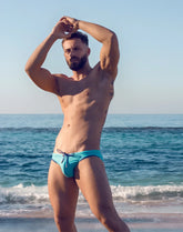 V22 rapid swim brief vibrant turquoise swim trunks with contrasting dark blue drawstring for quick drying use