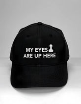 Wildmant ball cap black with white embroidered text my eyes are up here and upward arrow symbol on front