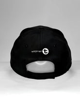 Black wildmant ball cap with white wildman t logo and circular emblem on the back side