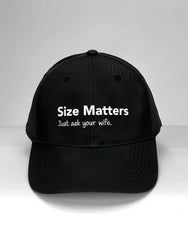 Black WildmanT baseball cap with white embroidered size matters just ask your wife text on front panel