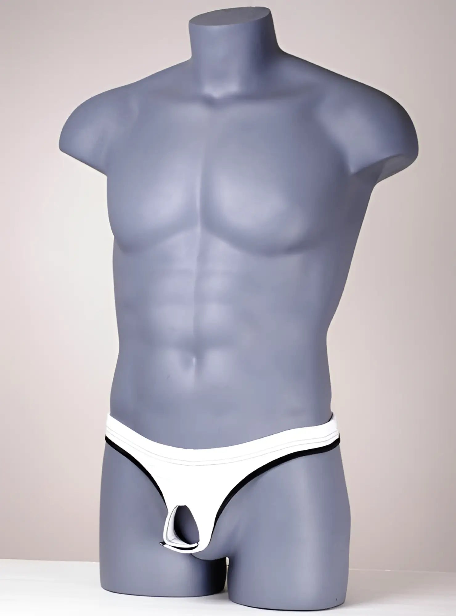 Wildmant the ball lifter protruder 2 white thong with black trim displayed on gray mannequin front side