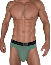 Green men’s cotton briefs with black elastic waistband featuring wildman brand logo and emblem wildmant cotton monster cock brief green