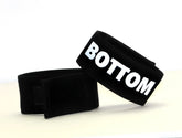 Black velour wristband with bold white bottom lettering for WildmanT Fetish Max Cock-Ring bottom use