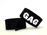 Black velour wristband with bold white gag lettering from wildmant fetish max cock ring gag accessory