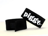 Black fabric wristband with white piggly logo from wildmant fetish max cock ring piggy collection