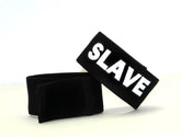 Black velour wristband with bold white embroidered slave lettering from wildmant fetish max cock-ring-slave product