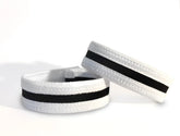 White elastic wristband with black stripe textured surface designed for wildmant slim cock ring use