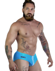 Wildman sportivo bikini teal bright blue form-fitting swim trunks with white side stripes and black wildman logo on left hip