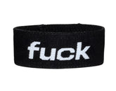 Black elastic wristband with white embroidered fuck text from wildmant verbal max cock ring fuck product line