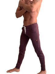Purple winter edition luxury-fleece joggers with white drawstrings and an orange logo on the thigh for athletic wear