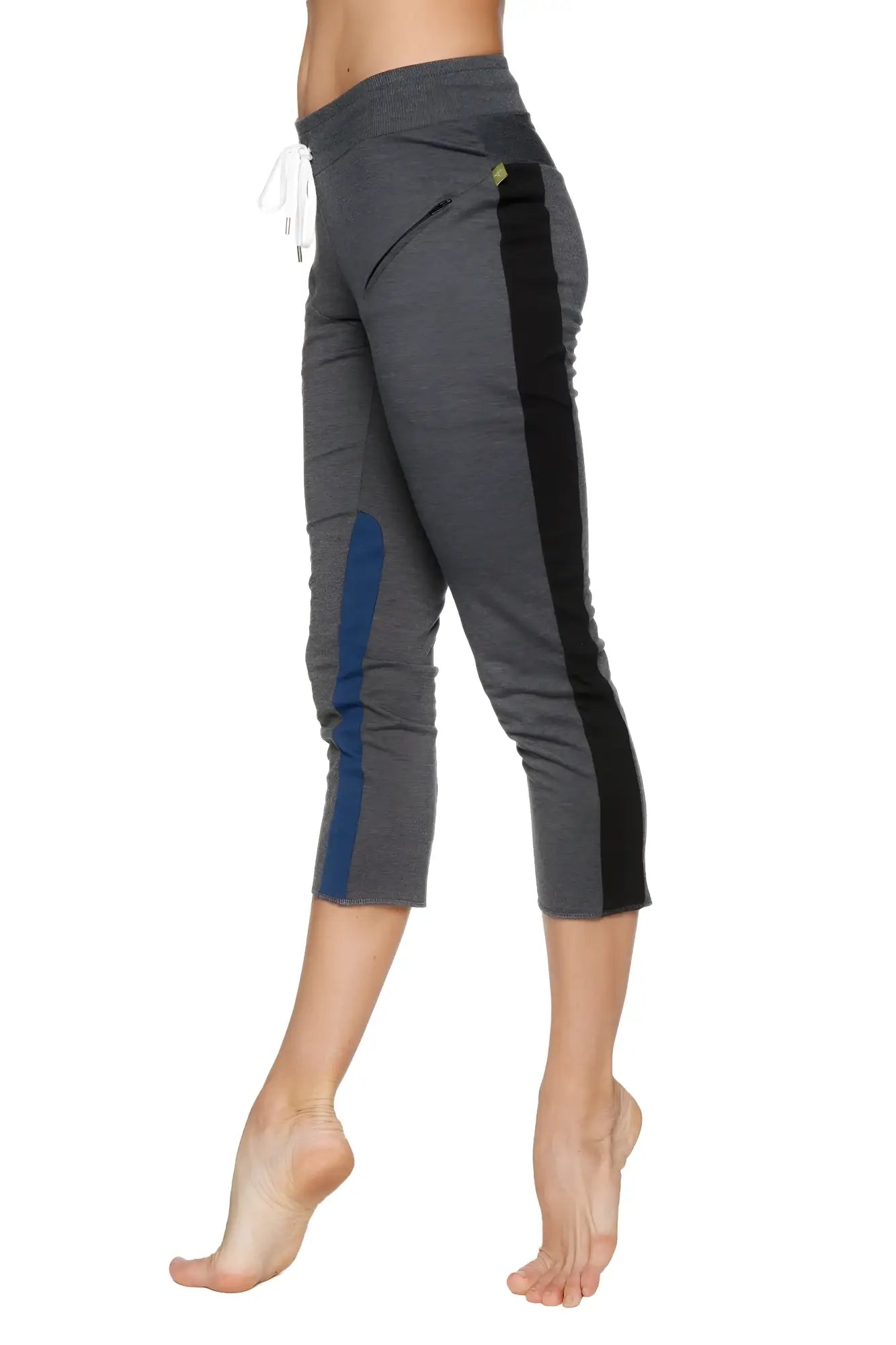 Women’s charcoal capri yoga pants with black and blue side panels, drawstring waist, zipper pockets, and yellow logo
