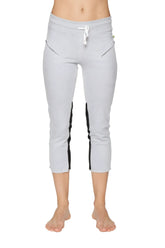 Women’s grey capri-length zipper pocket yoga pants with black side stripes and white drawstring waistband