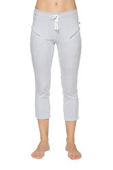 Light gray women’s 4/5 length capri yoga pant with white drawstring waistband and diagonal zipper pockets