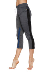 Women’s charcoal capri yoga pants with black and blue side panels, drawstring waist, zipper pockets, and yellow logo