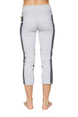Women’s light gray 4/5 length zip pocket capri yoga pants with dark gray side panels and green logo waistband