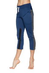 Women’s royal blue capri yoga pants with gray and black side panels, white drawstring, and zippered thigh pocket