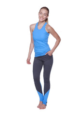 Women’s all-american racerback tank top in ice blue shown with blue and dark gray color-blocked athletic leggings