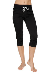 Women’s cuffed jogger yoga pants in solid black with white drawstring waistband and capri-length fit for athletic use