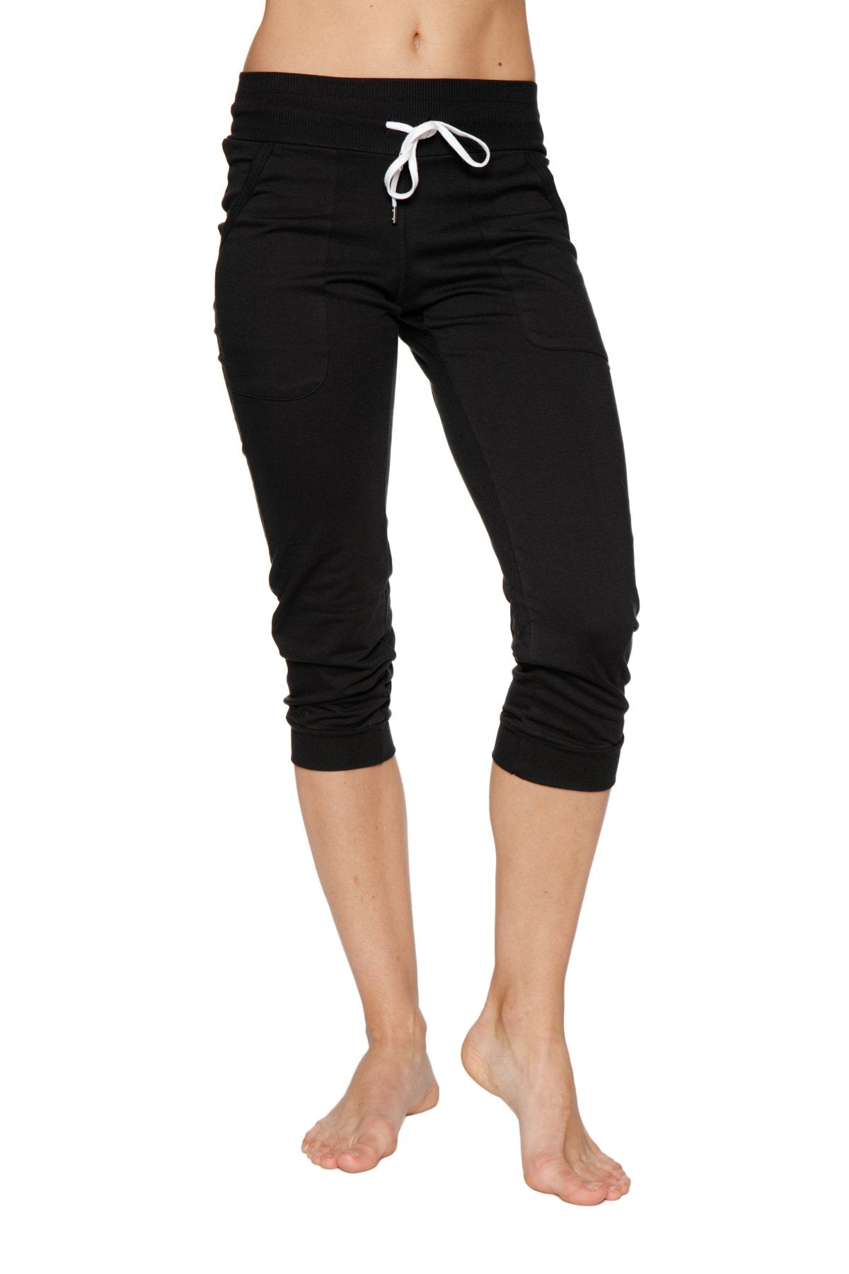 Women’s cuffed jogger yoga pants in solid black with white drawstring waistband and capri-length fit for athletic use