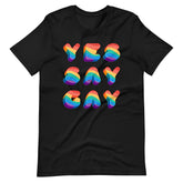 Black short-sleeved cotton t-shirt featuring yes say gay phrase in bold rainbow gradient letters for casual wear