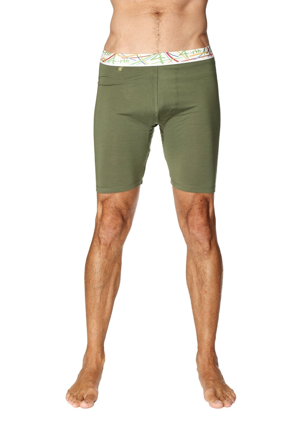 Olive green yoga compression shorts with white waistband featuring colorful abstract patterns in rainforest green