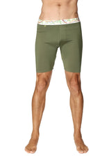 Olive green yoga compression shorts with white waistband featuring colorful abstract patterns in rainforest green