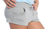 Gray heathered yoga training shorts with a drawstring waistband and side pockets for comfortable workouts