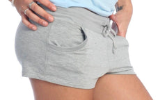 Gray heathered yoga training shorts with a drawstring waistband and side pockets for comfortable workouts
