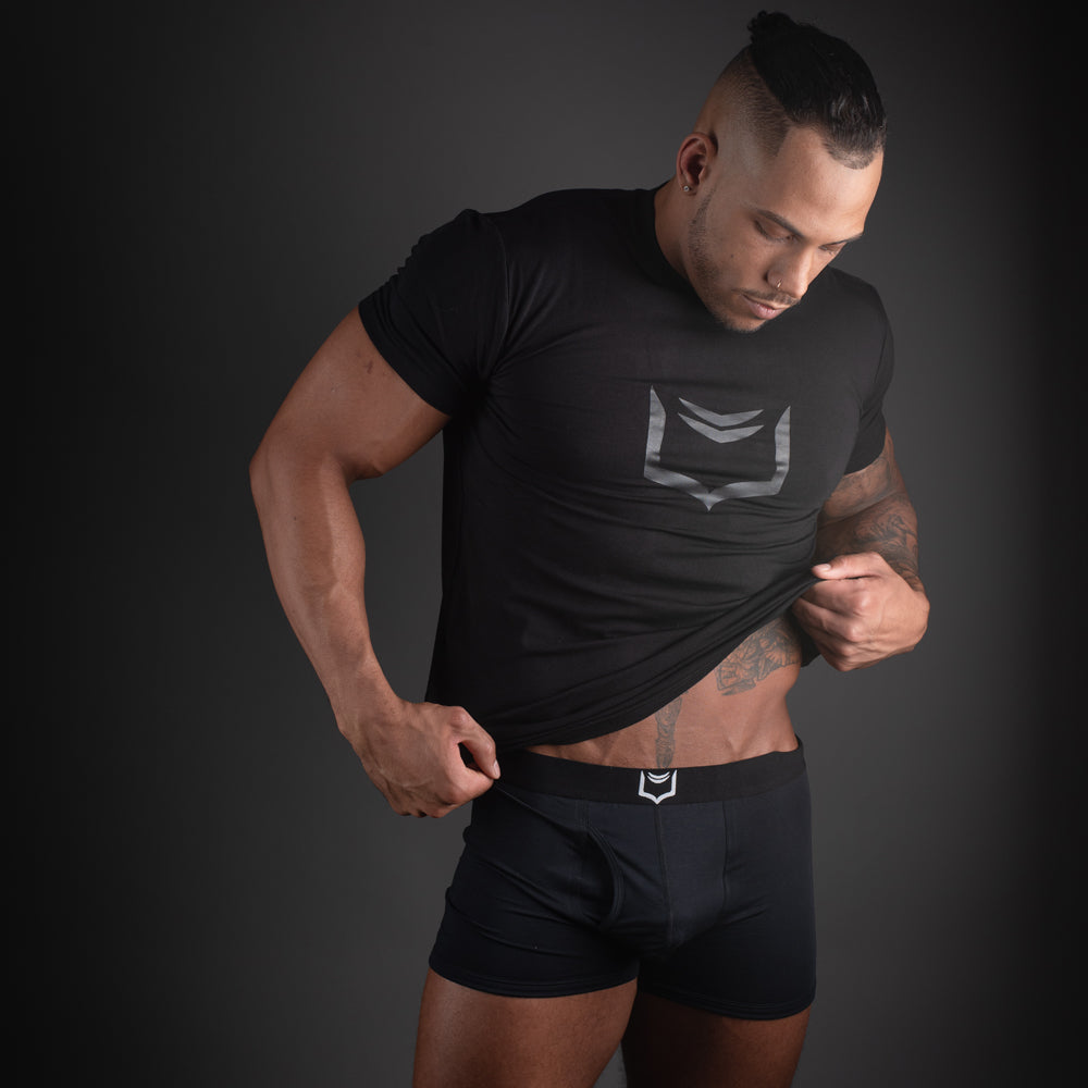 Black athletic t-shirt with a silver geometric logo on the chest featured in sheath 2.1 dual pouch trunks 3 pack bundle