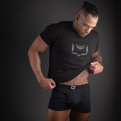 Black athletic t-shirt with a silver geometric logo on the chest featured in sheath 2.1 dual pouch trunks 3 pack bundle