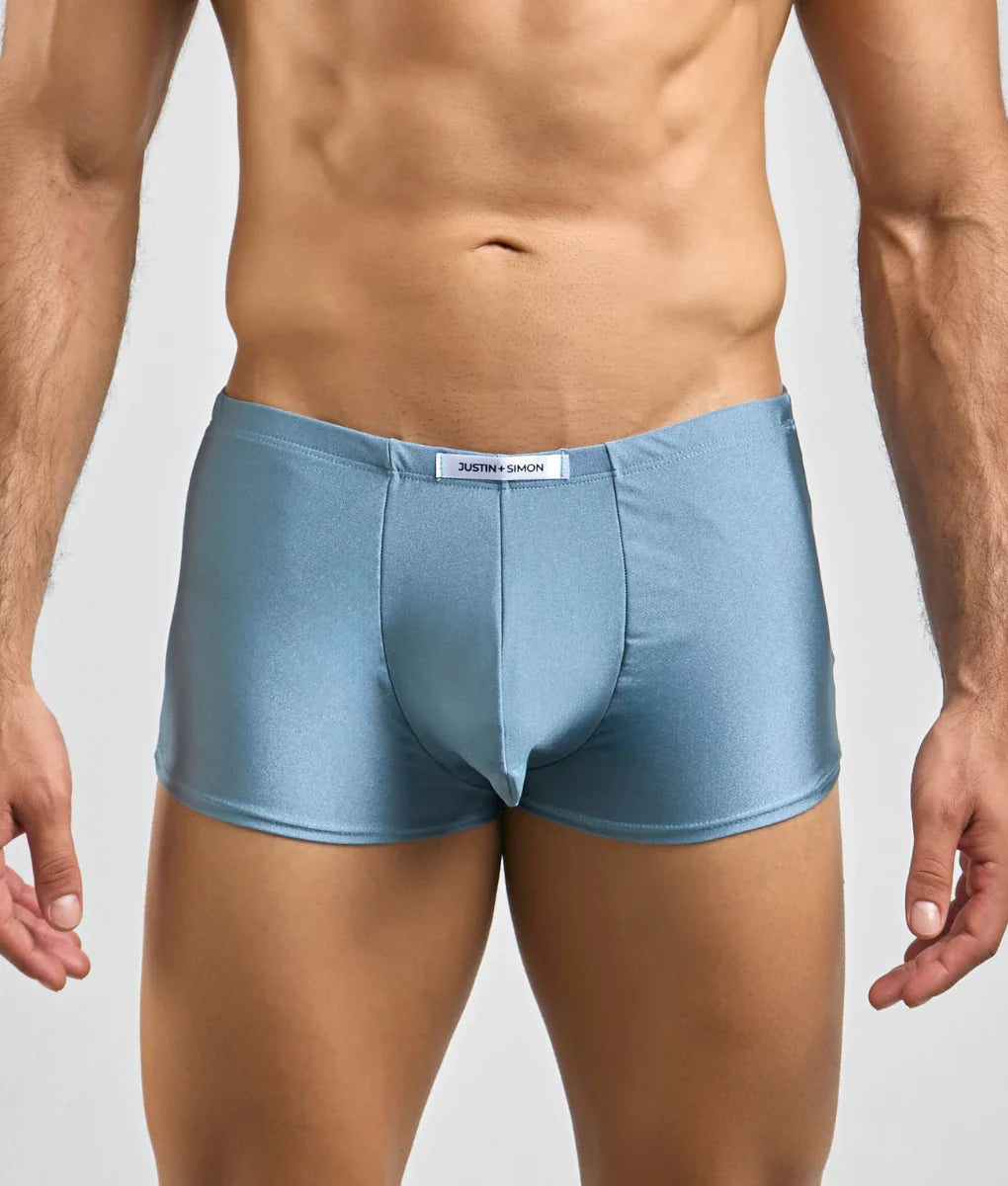 Justin + Simon classic boxer light blue shiny satin briefs with a white brand tag at the waistband front view