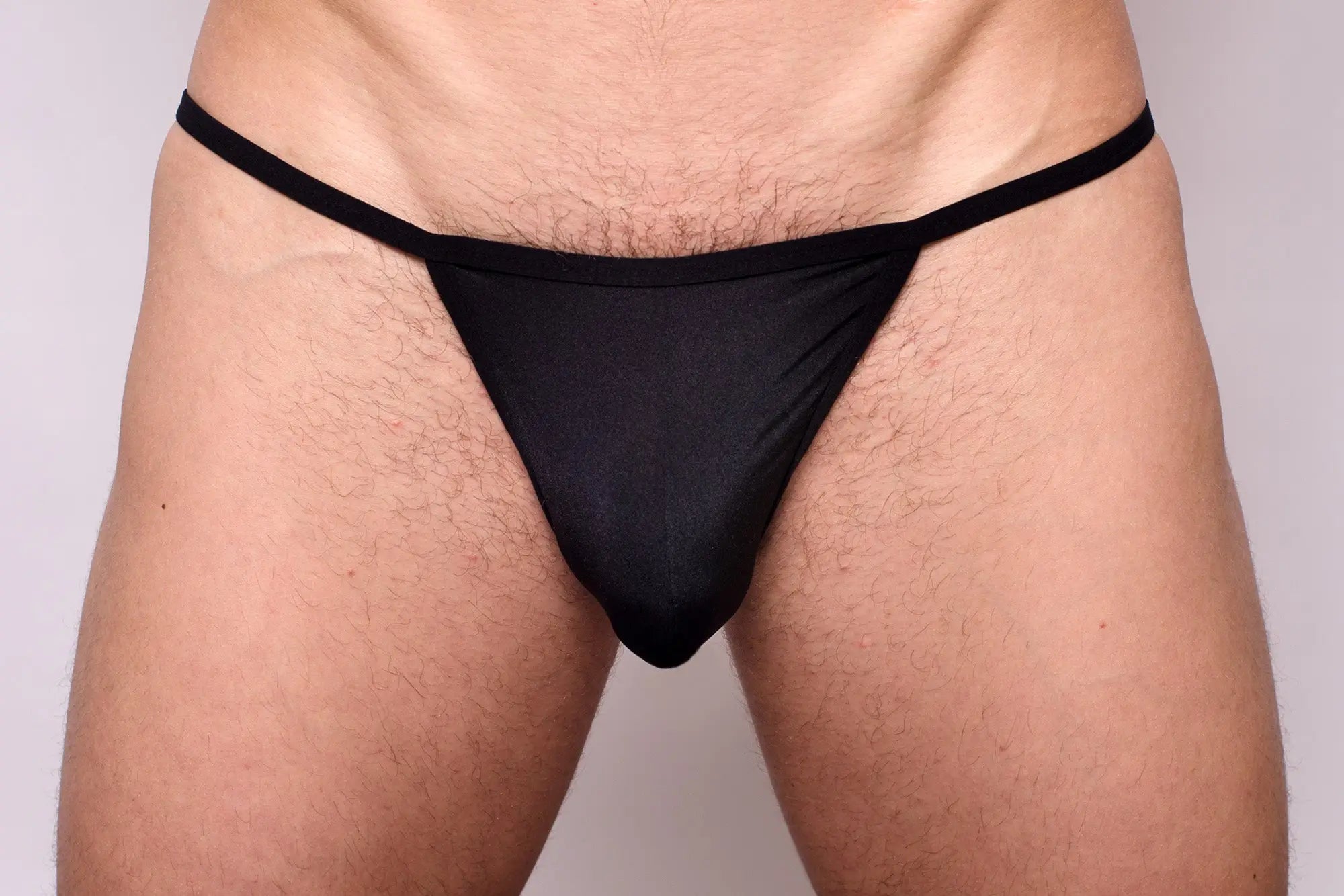 Black thong from 3-pack pride metro string bikini made of smooth stretchy fabric with narrow waistband shown from back