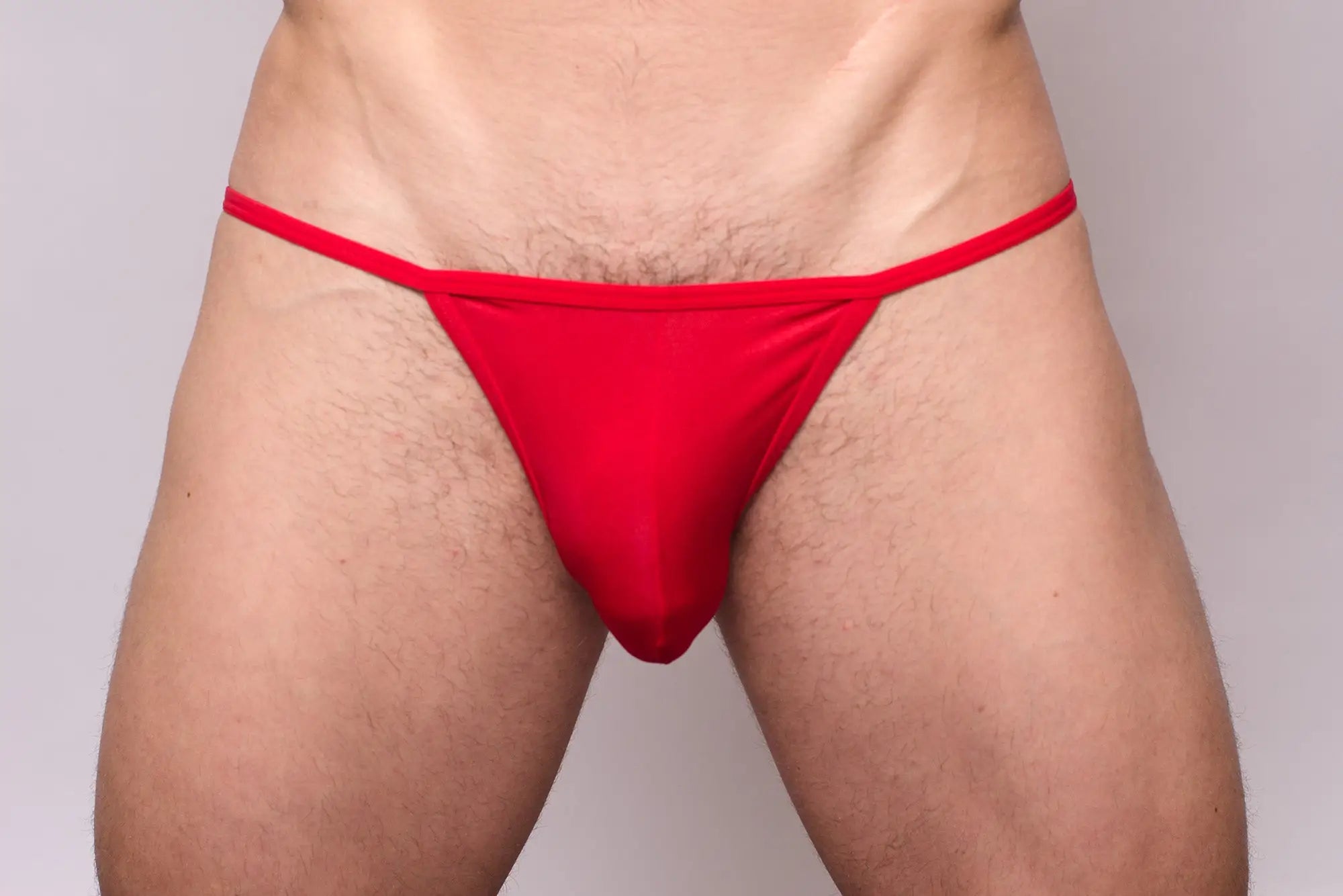 Red thong from 3-pack pride metro string bikini made of smooth stretchy fabric with a simple design shown from the back